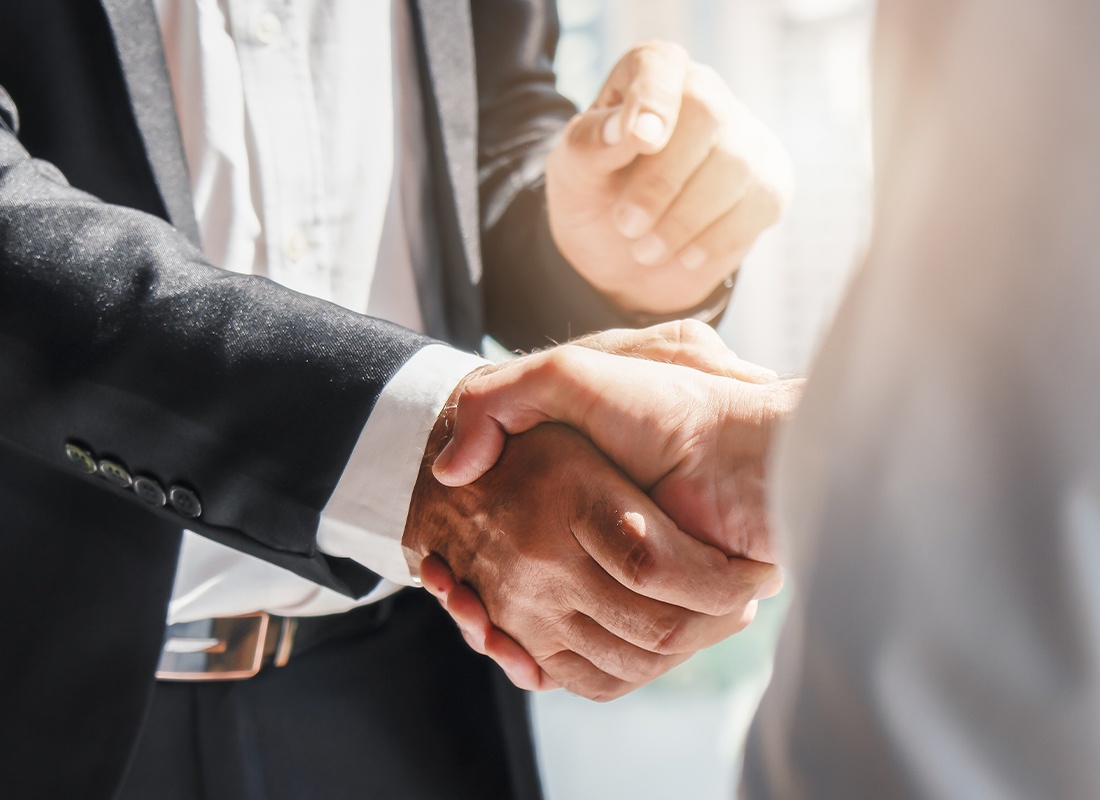 About Our Agency - Close-up Businessmen Shaking Hands After a Successful Business Merger and Acquisition