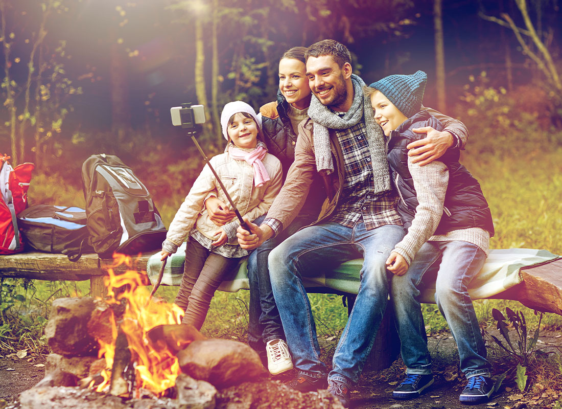Employee Benefits - Family With Taking Selfie Near Campfire While Camping in the Woods at Dusk